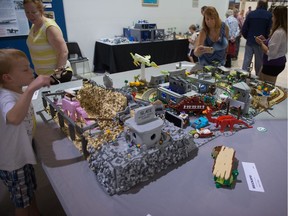 Visitors admire a Flintstones-themed build on display at Brickspo, a LEGO Expo held at the Western Development Museum in Moose Jaw.
