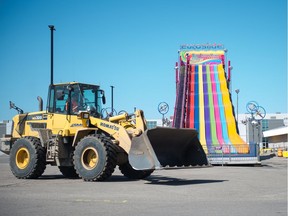 A slide sits in a largely vacant parking lot at Evraz Place, which will soon be full of attractions as the Queen City Exhibition gets underway.