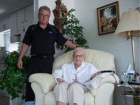 Rick Hofenk, left, stands next to his mother Petronella Hofenk in the living room of their Regina home. Petronella is dealing with the side effects of the drug Haldol.