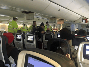 Emergency workers assist passengers of Air Canada AC 33 flight, which diverted to Hawaii after turbulence, at Honolulu airport, Hawaii, July 11, 2019.