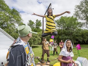 Micheal Martin, left, and Mara Teare, right, listen to a bee played by Megan Zong in Sum Theatre's Theatre in The Park production of The Young Ones.