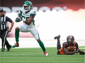 The Saskatchewan Roughriders' Loucheiz Purifoy takes off on an 87-yard kickoff-return touchdown after evading the B.C. Lions' Crezdon Butler on Saturday at BC Place.