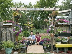 Thon (left) and Phoukham Phommavong pose in their yard with their dog Tictac. The couple's home is one of the stops on the New Dance Horizons Secret Gardens Tour, July 12-14, 2019, in Regina.