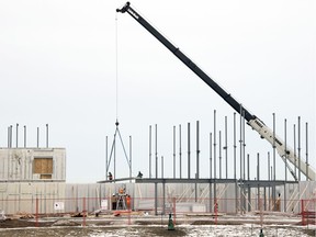Construction crews work on a multi-unit housing project in northwest Regina on Dec. 17, 2018.