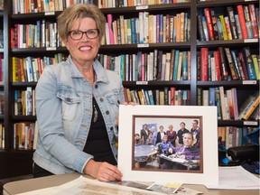 REALM founder Donalda Jones sits holding a photo of her son Steven Ripplinger, (bottom right of photo) in The Bentley on Hillsdale Street.
