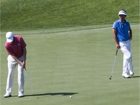 Micah Burke of Los Angeles California, right, watches Trey Denton putt on the No. 7 green during the 2013 Dakota Dunes Open at Dakota Dunes golf course south of Saskatoon July 4, 2013.{RICHARD MARJAN/STARPHOENIX}