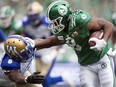 Winnipeg Blue Bombers defensive back Chris Randle (8) can't bring down Saskatchewan Roughriders running back Marcus Thigpen (8) in the Labour Day Classic at Mosaic Stadium in Regina. TROY FLEECE / Regina Leader-Post