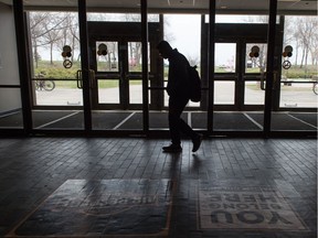 A student walks through the University of Regina near the Archer Library.