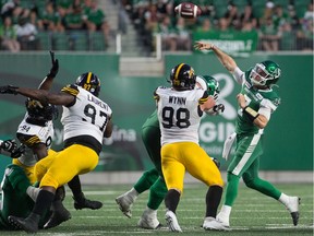 REGINA, SASK : August 1, 2019  -- Saskatchewan Roughriders quarterback Cody Fajardo (7) passes the ball under pressure during a game against the Hamilton Tiger-Cats at Mosaic Stadium. BRANDON HARDER/ Regina Leader-Post