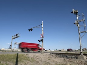 Vehicles travel over a rial crossing on the Ring Road near Winnipeg Street in Regina.