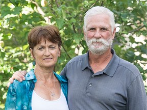 Kim Loffler, left, who in 1975 was the torch-bearer of the Western Canada Summer Games in Regina, stands next to her husband Jeff Loffler in front of their home.