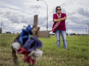 Agatha Eaglechief stands by a memorial cross where her son Austin was killed in a car chase with police in Saskatoon, SK on Friday, August 16, 2019.
