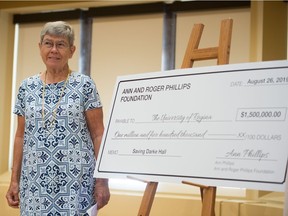 Ann Phillips of the Ann and Roger Phillips Foundation stands in the University of Regina's College Avenue campus next to a symbolic cheque made out for $1.5 million, a donation from the foundation for the renovation of Darke Hall.
