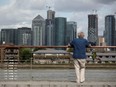 A man looks out onto the Canary Wharf financial district in London, Britain August 11, 2019.