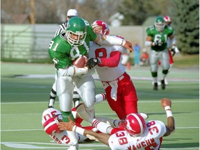 Saskatchewan Roughriders slotback Ray Elgaard tramples Calgary Stampeders defenders at Taylor Field on Oct. 23, 1993.