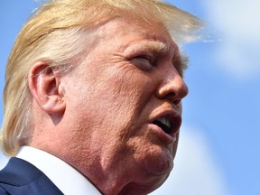 U.S. President Donald Trump speaks to the press before boarding Air Force One in Morristown, New Jersey, on August 18, 2019.