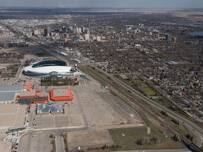 An aerial photo shows Evraz Place and Mosaic Stadium with the city's downtown in the background.