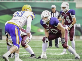 Offensive tackle Logan Ferland, 60, protects the blind side of Regina Thunder quarterback Blake Scherle, 14.