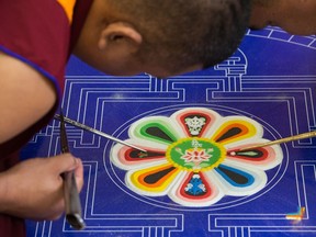 Tibetan monks from the Dzongkar Choede Monastery create a sand mandala at the Buddhist Centre of Regina. It is being constructed over five days and on Sept. 1st, they will do blessing and deliberately destroy the mandala to symbolize that nothing lasts forever.