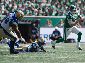 REGINA, SASK : September 1, 2019  -- Saskatchewan Roughriders quarterback Cody Fajardo (7) evades a tackle during a game against the Winnipeg Blue Bombers at Mosaic Stadium.  BRANDON HARDER/ Regina Leader-Post