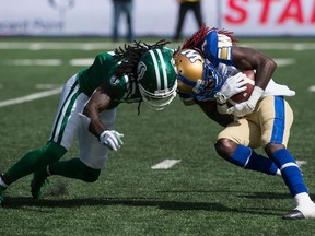 Saskatchewan Roughriders defensive back Ed Gainey (11) and Winnipeg receiver Lucky Whitehead butt heads during Sunday's 55th annual Labour Day Classic.