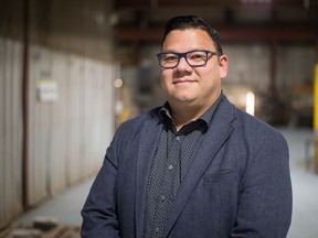 Jada Yee, member of Regina's Board of Police Commissioners, stands in the shop at Pro Metal Industries, where he works.