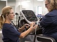Mary Anne Schuweiler, left, a joy master at SPARKS METHOD, demonstrates monitoring blood pressure on a treadmill on owner Brenda Yungwirth in Regina. A joy master is someone who is a health educator and follows the client through the exercises.