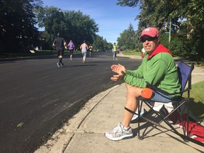 Lakeview resident Mark Furlan cheers on runners as they complete the Queen City Marathon on Sunday, Sept. 9, 2019.