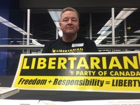 James Plummer, the Regina-Qu'Appelle Libertarian Party of Canada candidate for Regina—Qu'Appelle, sits at his booth at the Regina Public Library's Meet and Greet All Candidates event early in the campaign.