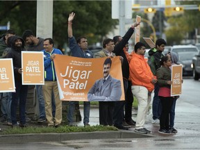 Supporters for NDP candidate Jigar Patel (pictured, in orange jacket) campaign Wednesday afternoon on the corner of Lewvan Drive and Dewdney Avenue in Regina.