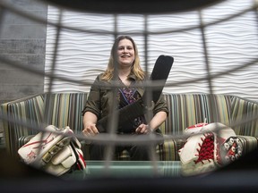 Tracey Arnold, a former world-calibre arm wrestler and current sledge hockey goalie, is seen though her mask with some of her equipment Thursday morning.