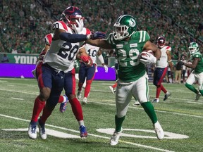 Saskatchewan Roughriders running back William Powell, right, was named one of the CFL's Top Performers of the week on Tuesday.