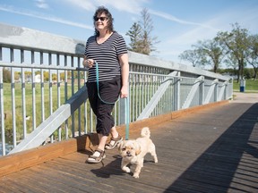 Mona Neher, who is living with an incurable cancer called multiple myeloma walks her dog in Carlton Park.