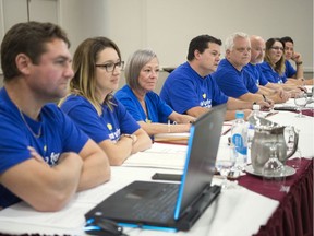 Chris Macdonald, fourth from left, assistant to the national president of Unifor, sits with the bargaining committee for Sasktel employees at the Delta Hotel in Regina.