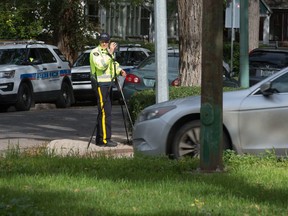 An RCMP officer uses photo radar to ensure motorists are observing the speed limit in a school zone on College Avenue. on Friday.