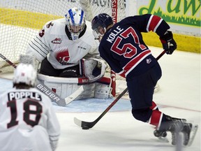 Moose Jaw Warriors goalie Bailey Brkin keeps a close eye on the Regina Pats' Ty Kolle during WHL action at the Brandt Centre on Friday.