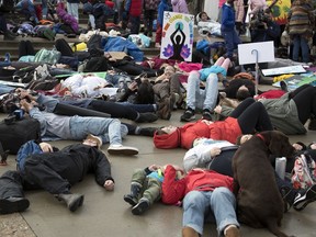 People participate in a "die-in" during Regina's global climate strike.