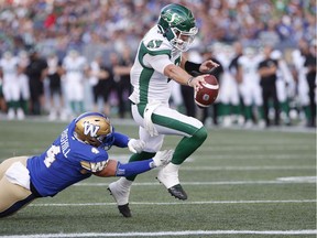 CP-Web. Winnipeg Blue Bombers' Adam Bighill (4) can't stop Saskatchewan Roughriders quarterback Cody Fajardo (7) from closing the goal line for the touchdown during the second half of CFL action in Winnipeg Saturday, September 7, 2019.