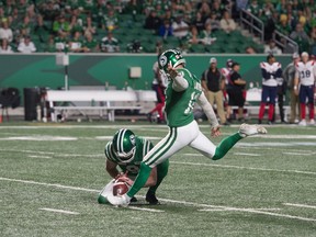 Jon Ryan pins the ball for placekicker Brett Lauther on the Saskatchewan Roughriders' game-winning field goal against the Montreal Alouettes on Saturday.