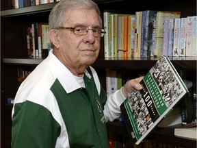 Former Saskatchewan Roughriders president Gord Staseson is shown in 2014 with a team history book that he co-authored.