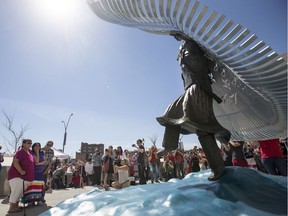 SASKATOON,SK--MAY 05/2017-0506 News Police Statue- Merilyn Napope. left, and Mike Poitras, right, comfort Gwenda Yuzicappi during the unveiling of a missing and murdered indigenous women monument at the entrance to the Saskatoon Police headquarters a  in Saskatoon, SK on Friday, May 5, 2017. Yuzicappi's daughter Amber Redman went missing in 2005, and her remains where found in 2008. The monument is named Wicanhpi Duta Win, Amber Redman's Dakota name. It was inspired by her and her dancing.(Saskatoon StarPhoenix/Liam Richards)