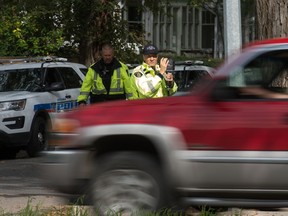 An RCMP officer uses photo radar to ensure motorists are observing the speed limit in a school zone on College Avenue.