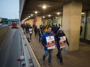 Unifor members walk a picket line outside SaskTel's main office on Saskatchewan Drive.