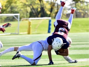 Greg Lamb, 9, of the Regina Thunder takes a hit after making a catch against the Calgary Colts on Sunday at Leibel Field.