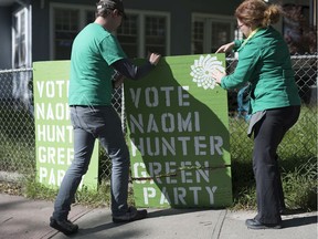 REGINA, SASK :  October 7, 2019  --   Michael Wright, left, and Green Party candidate for Regina-Lewvan Naomi Hunter repair a campaign sign that was damaged over the weekend in Regina. TROY FLEECE / Regina Leader-Post