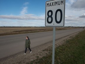 Leshae Bell walks on the side of Dewdney Avenue on the city's west end. Bell says she has to walk along the section of the street where there is no sidewalk and the speed limit is 80 km/h get to the nearest bus stop to the east.