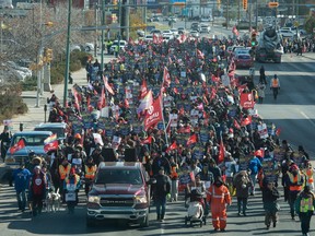 Striking Unifor members walk along Saskatchewan Drive near the Casino Regina during a march past a number of Crown Corporation buildings in downtown Regina on Oct. 11, 2019.