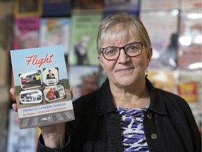Deana Driver, co-author, editor and publisher of Flight: Stories of Canadian Aviation Vol. 1, holds a copy of her book in her office in Regina.