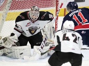 Vancouver Giants goalie David Tendeck makes a save on the Regina Pats' Carter Massier during WHL action at the Brandt Centre on Saturday.