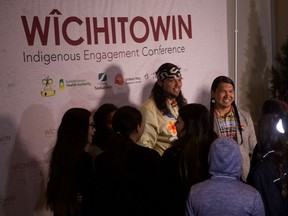Amazing Race Canada winners Anthony Johnson and Dr. James Makokis greet the crowd after giving presentations at the Wîcihitowin Indigenous Engagement Conference at TCU Place in Saskatoon on Oct. 16, 2019.